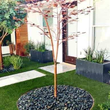 metal tree outdoor sculpture fountains shown in a front yard with modern design