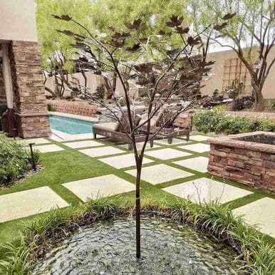 metal tree outdoor sculpture is also a fountain